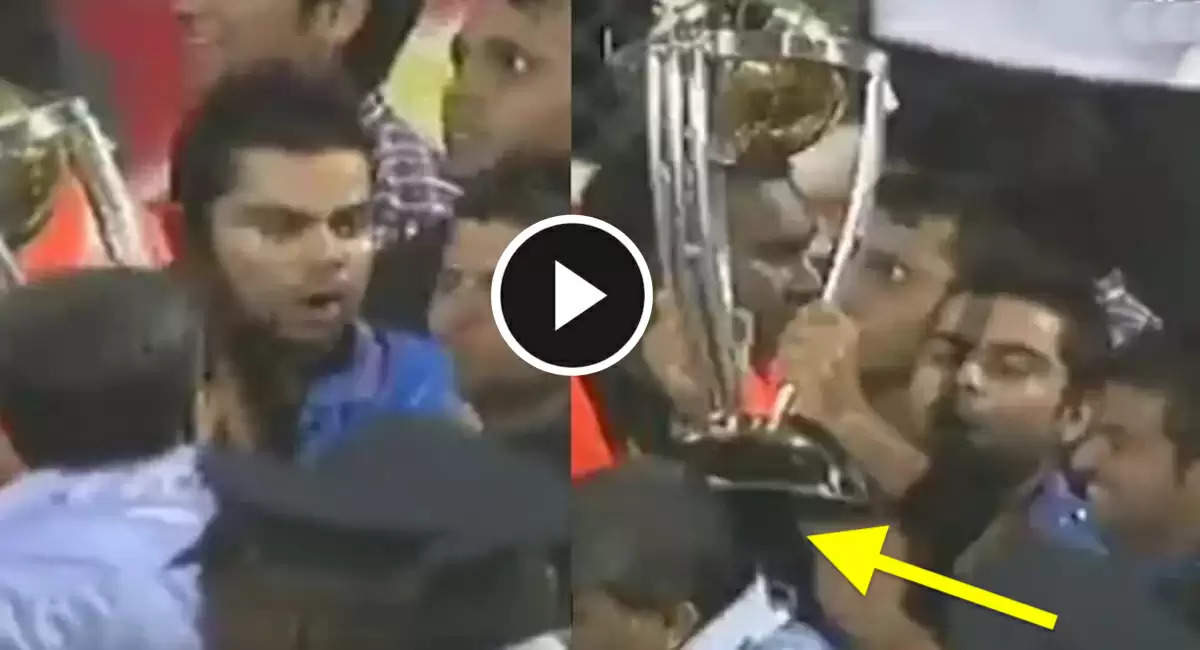 Virat-Kohli-and-Suresh-Raina-hitting-old-man-with-World-Cup-trophy-lg